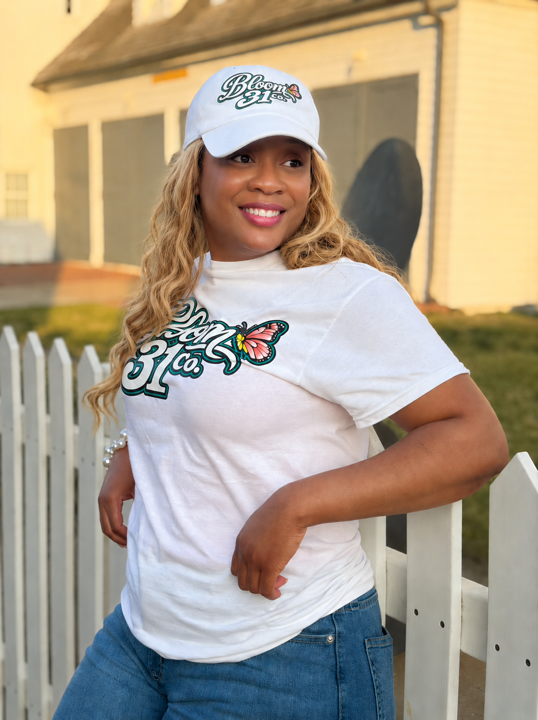 Jacinta Faison, Founder of Bloom31Co, wearing a Bloom31Co t-shirt and cap